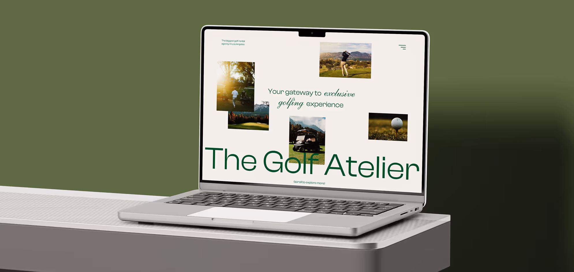 Silver laptop on a gray table displaying a webpage with golf images and text reading 'The Golf Atelier' on a green background.